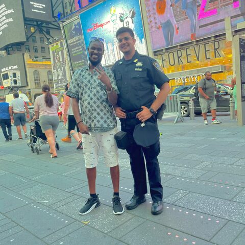 Ali Akbar on NYPD Auxiliary patrol in Times Square posing with a visitor