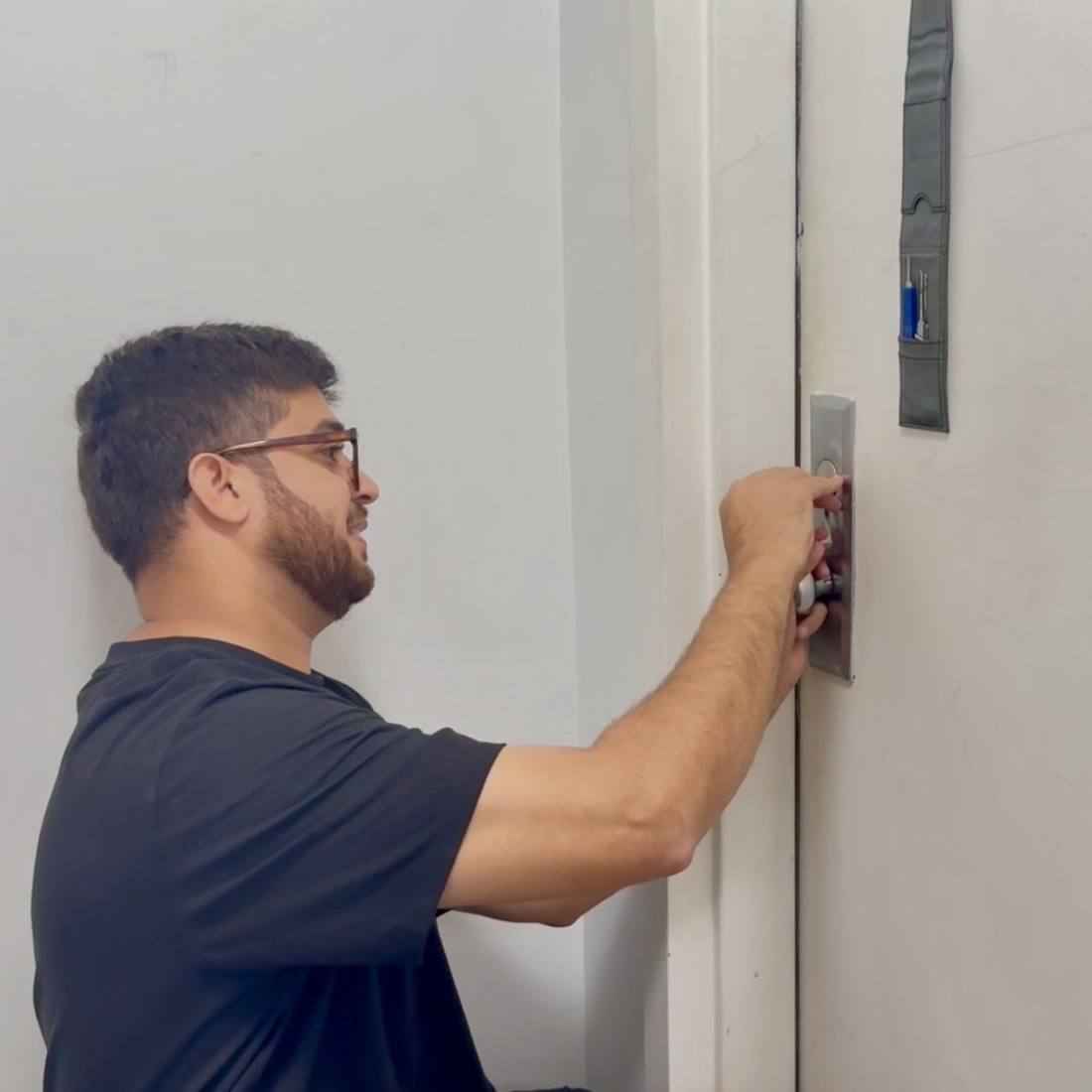 Aura Locksmith technician picking a residential door lock during an emergency lockout call in Brooklyn