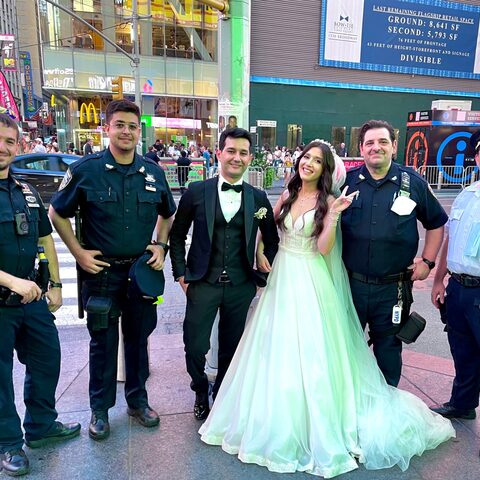 Ali Akbar in NYPD Auxiliary uniform with fellow officers and a wedding couple in Times Square, NYC